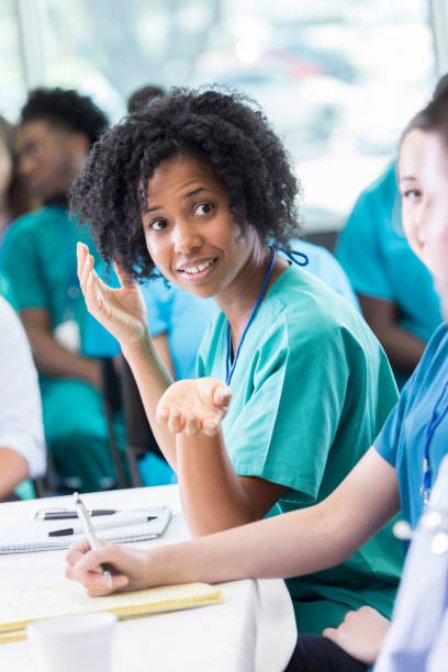 istock Doctor talks with colleagues during panel discussion at healthcare conference 874205446