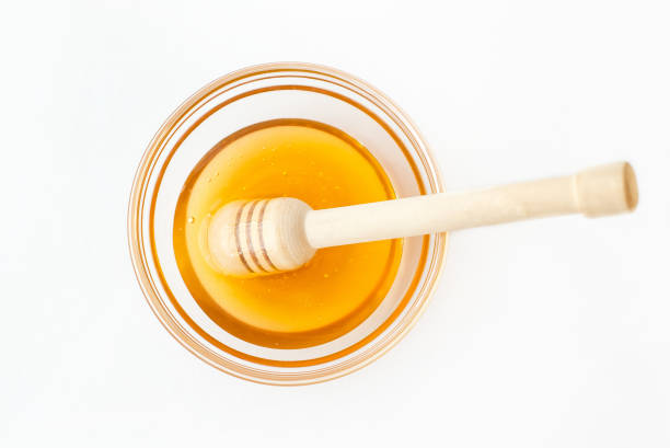 istock Dipper Lying in Bowl with Fresh Honey 874218346