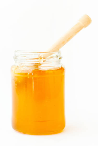 istock Dipper Lying in Jar with Sweet Honey 874218366
