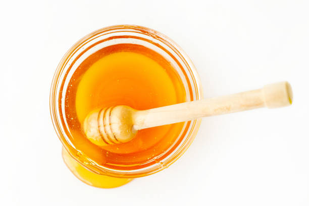 istock Dipper in Bowl with Honey and Splash 874218376