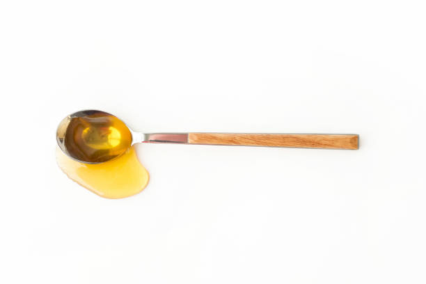 Spoon and Honey Splash Spoon and honey splash. Isolated top view on white background. teaspoon stock pictures, royalty-free photos & images
