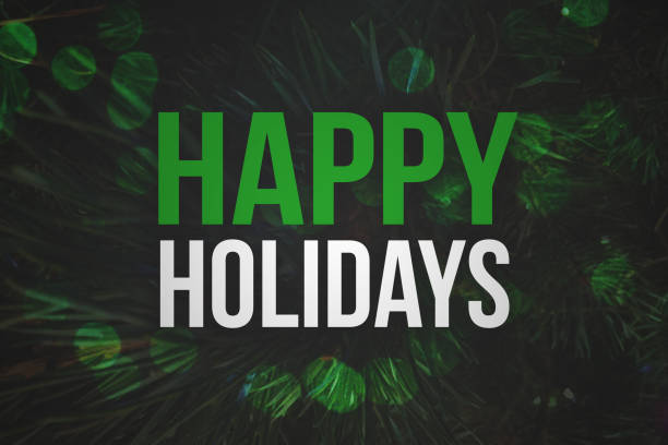istock Happy Holidays Text with Pine Branches Background and Bokeh Lights 874218568