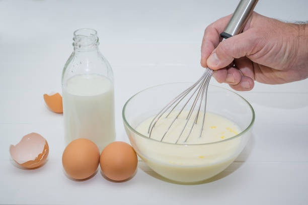 istock The man whips whisk milk and egg mixture with sugar. 874225046