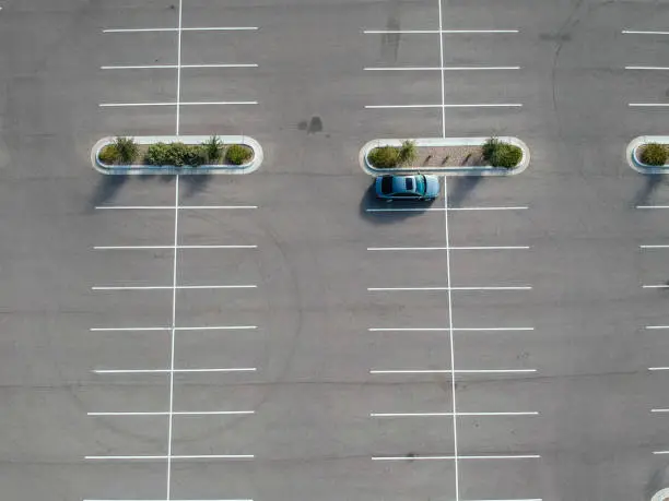 Photo of A car parked at a large parking lot.