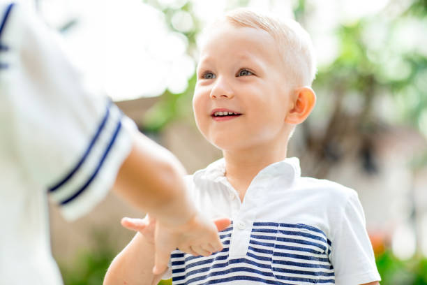 istock Smiling Boy Playing with Sister Outdoors 874225326