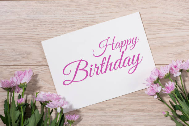istock Pink flowers and empty paper for your text on wooden background 874231262