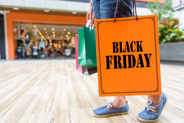 closeup woman holding shopping bags in the shopping mall with black friday words concept. - ipad shopping gift retail imagens e fotografias de stock