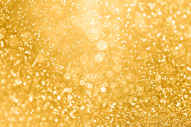 Gold Glitter Sparkle Background for Christmas, Wedding Anniversary or Birthday Elegant gold glitter sparkle confetti background for golden happy birthday party invite, 50th wedding anniversary, glitz and glam, glitzy coins, Christmas ad or New Year’s Eve champagne color backdrop 50th anniversary photos stock pictures, royalty-free photos & images
