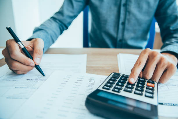 istock Male hands working with papers_tone 874231916