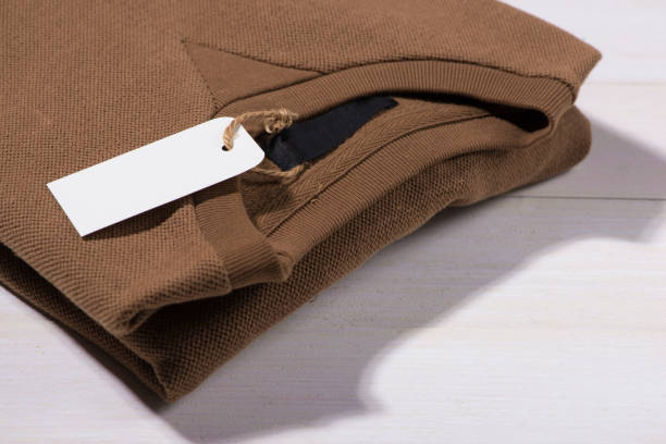 istock Shirt price tag. Rectangular tag is attached to a sweater 874233276