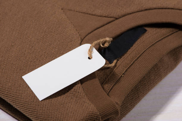 istock Shirt price tag. Rectangular tag is attached to a sweater 874234350