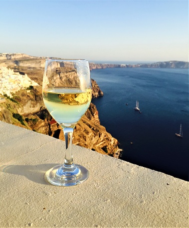 Wine glass resting on ledge in Santorini
