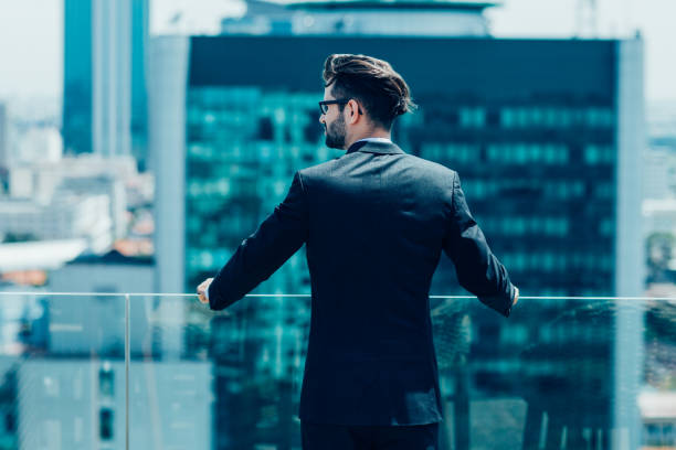 istock Young Businessman Looking at City 874237390