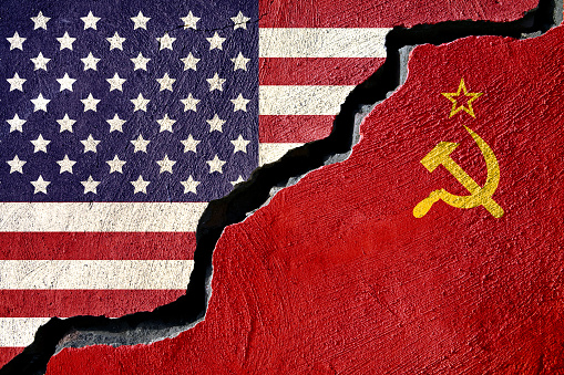 Concept american and Russia flag on cracked background