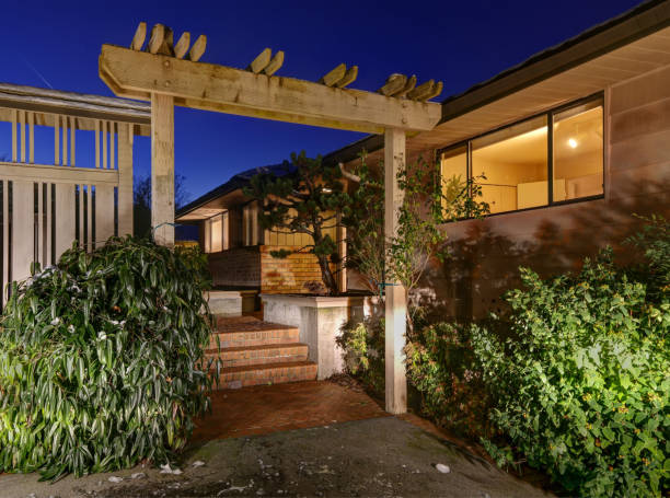 istock Sunset view of two story home with decorative pergola 874244224