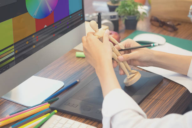 istock Artist working on creative desk with wood model and computer. 874250702