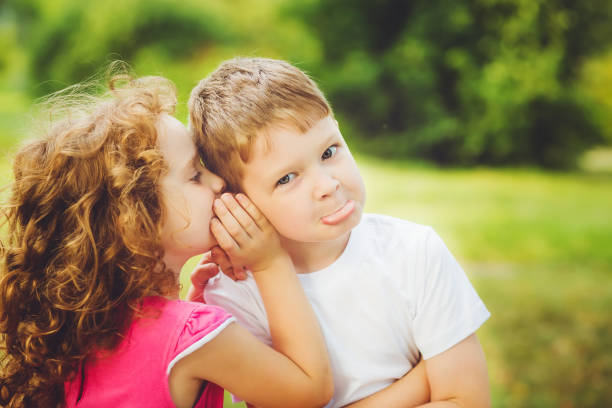 istock Little boy and girl whispers. 874250770