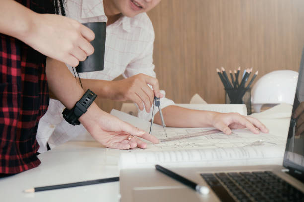 istock Cooperation Corporate of engineer meeting for architectural project working with partner and engineering tools on workplace Planning Design Draw Teamwork. 874250900