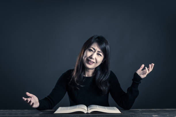 istock woman and a book, dark studio 874254430