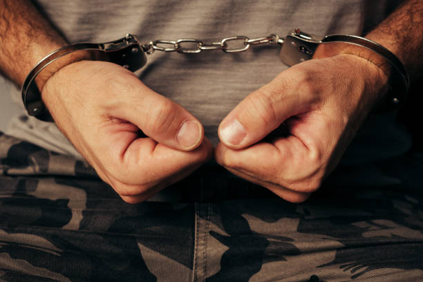 istock Handcuffed soldier in military army clothes 874257422