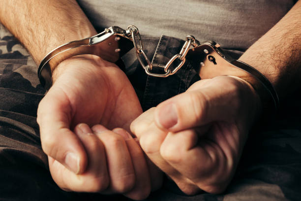 istock Handcuffed soldier in military army clothes 874257512