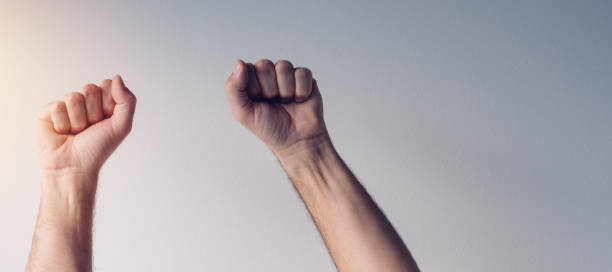 istock Clenched fists and arms raised in victorious manner 874258206