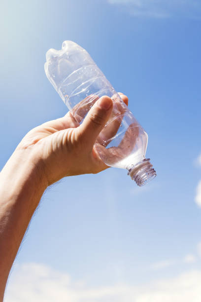 istock empty bottle of water in front of blue sky 874259088