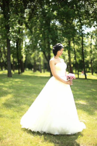 istock in full growth. pensive bride with bouquet 874260180