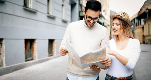 istock Happy tourists sightseeing city with map 874262614