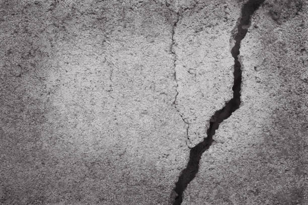 istock abstract old grungy texture, cracked concrete wall covered with gray cement surface for background and design art work. 874262664