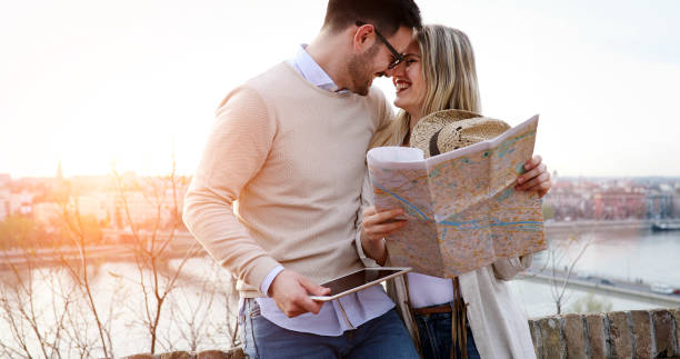 istock Happy tourists sightseeing city with map 874263284