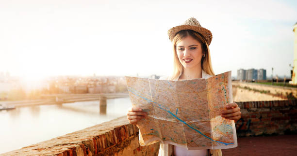 istock Tourist woman looking at map 874265958