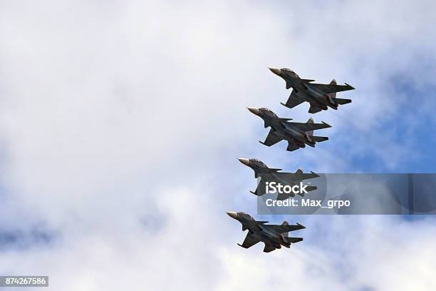 Four Fighters Jet Flying In Formation Against A Blue Sky Stock Photo - Download Image Now