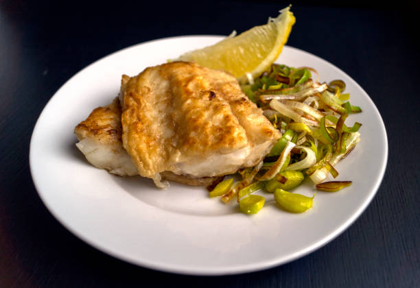 istock Grilled fish with leek and lemon. 874267948