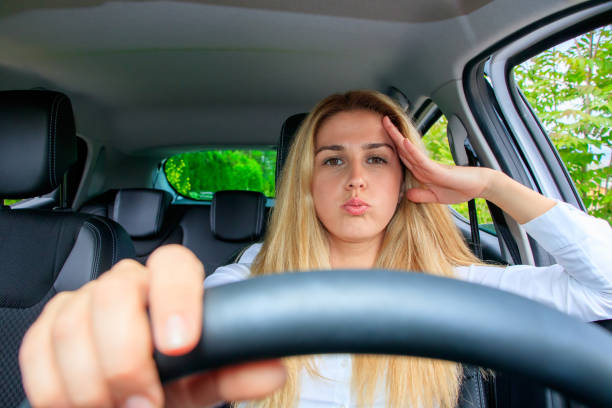 istock Woman is driving her car 874277344