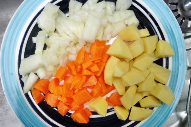 istock carrot, potatoes and onion prepared for cooking. 874277632