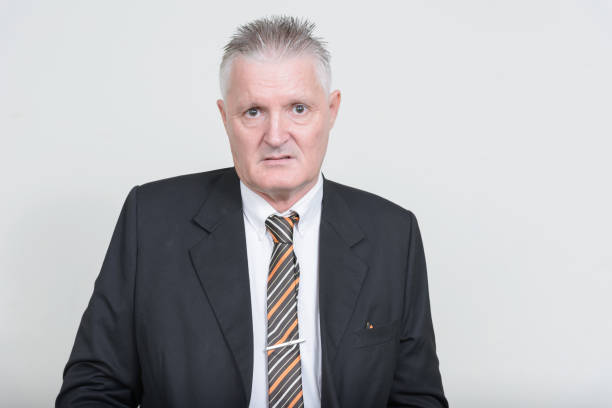 istock Mature handsome businessman against white background 874277964