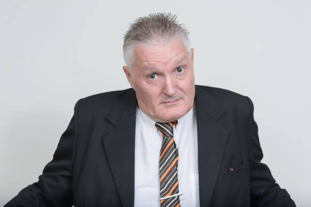 istock Mature handsome businessman against white background 874278128