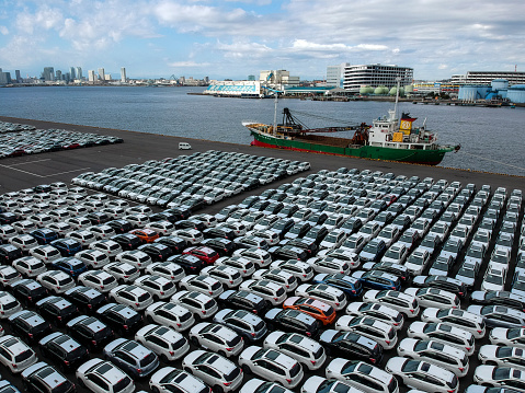 A lot of cars are lined up for importing and exporting cars to the port.