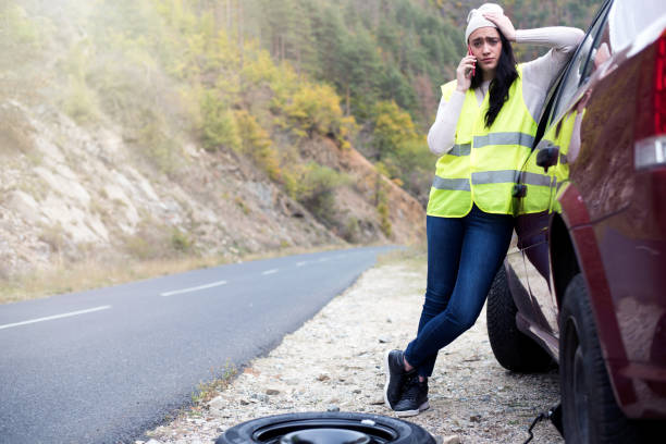 istock Young female driver wearing a high visibility vest 874290610