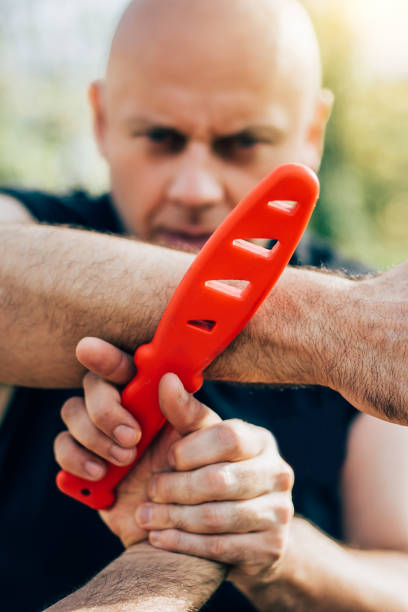 istock Self defense disarming technique against threat and knife attack 874293690