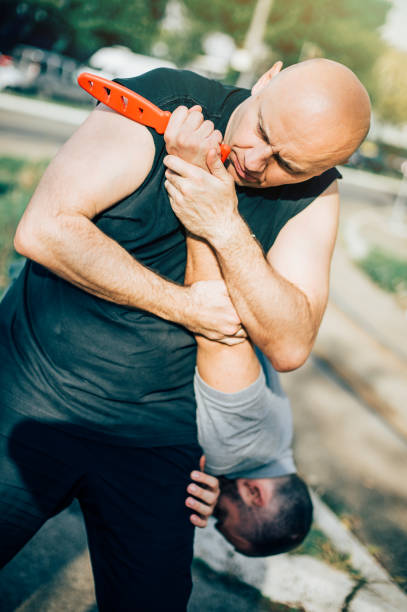 istock Self defense disarming technique against threat and knife attack 874293908