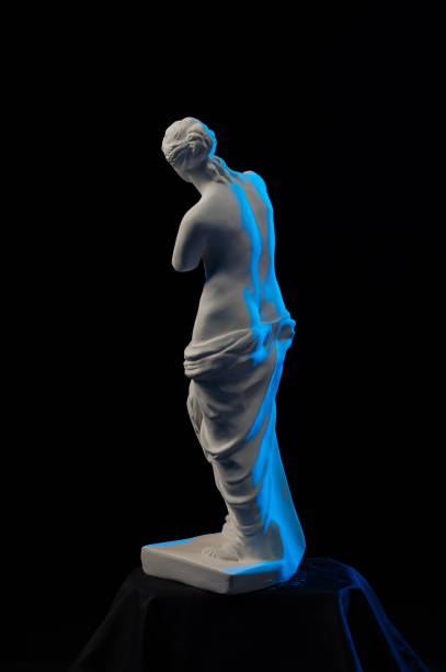 istock Statue of Venus in blue light on a black background 874294906