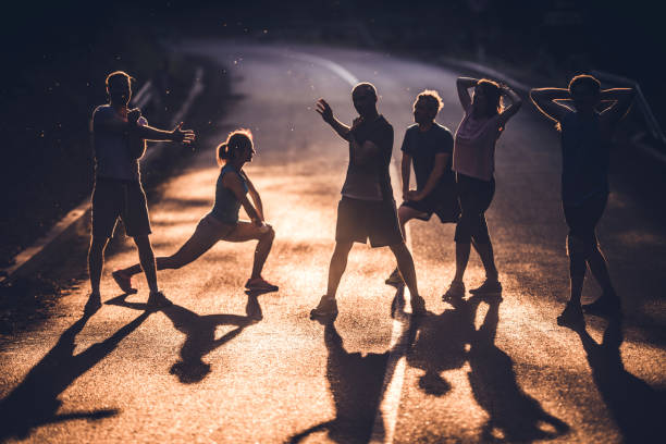 istock Determined athletes doing stretching exercises before marathon race at sunset. 874294934