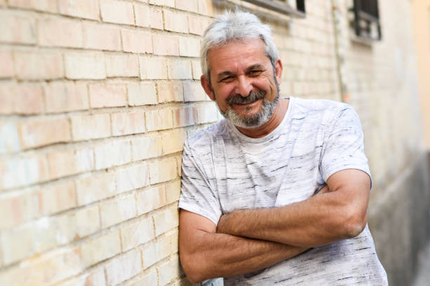 istock Mature man smiling looking at camera in urban background 874294990