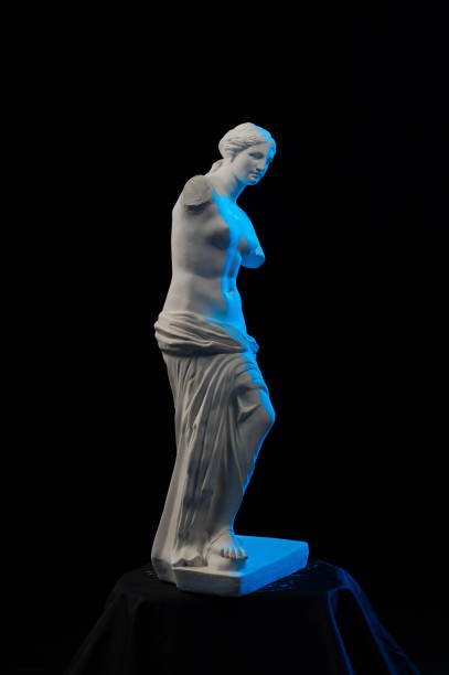 istock Statue of Venus in blue light on a black background 874297184