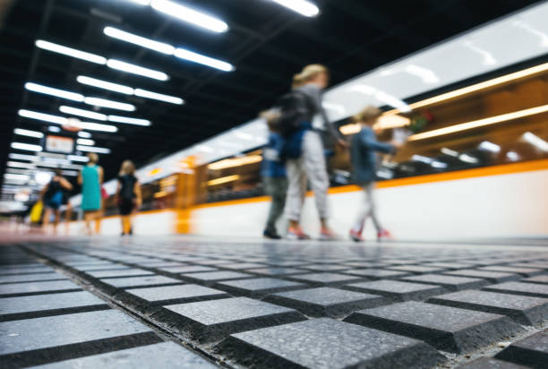 People waiting on subway station platform in Barcelona. Defocused image, view from below.