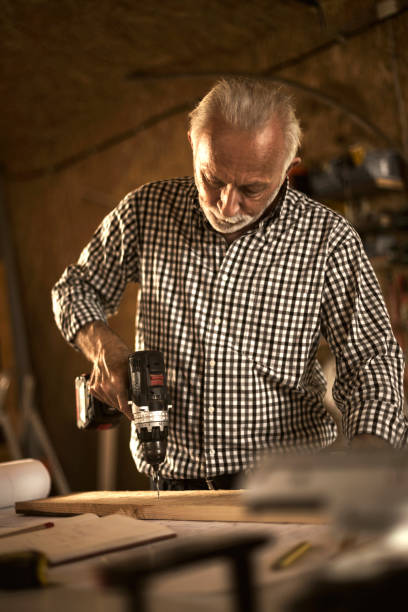 istock Mature carpenter making furniture 874301154