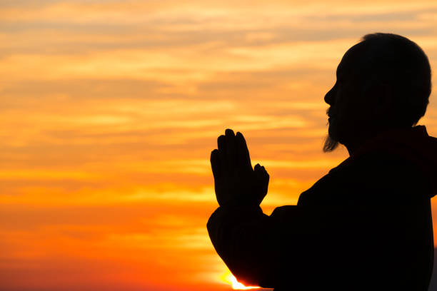 istock Senior asian man praying on top mountain 874301530