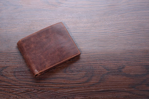 istock Brown man wallet on wooden background. Closeup 874301732